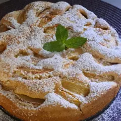 Szybki jabłecznik na oleju, posypany cukrem pudrem i udekorowany listkiem mięty. Idealny na deser.